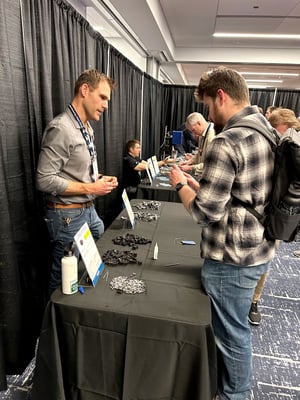 Two people discussing a 3D printing application at AMUG conference workshop